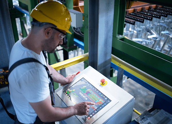 IoT dashboard in smart manufacturing plant showing real-time machine data and analytics